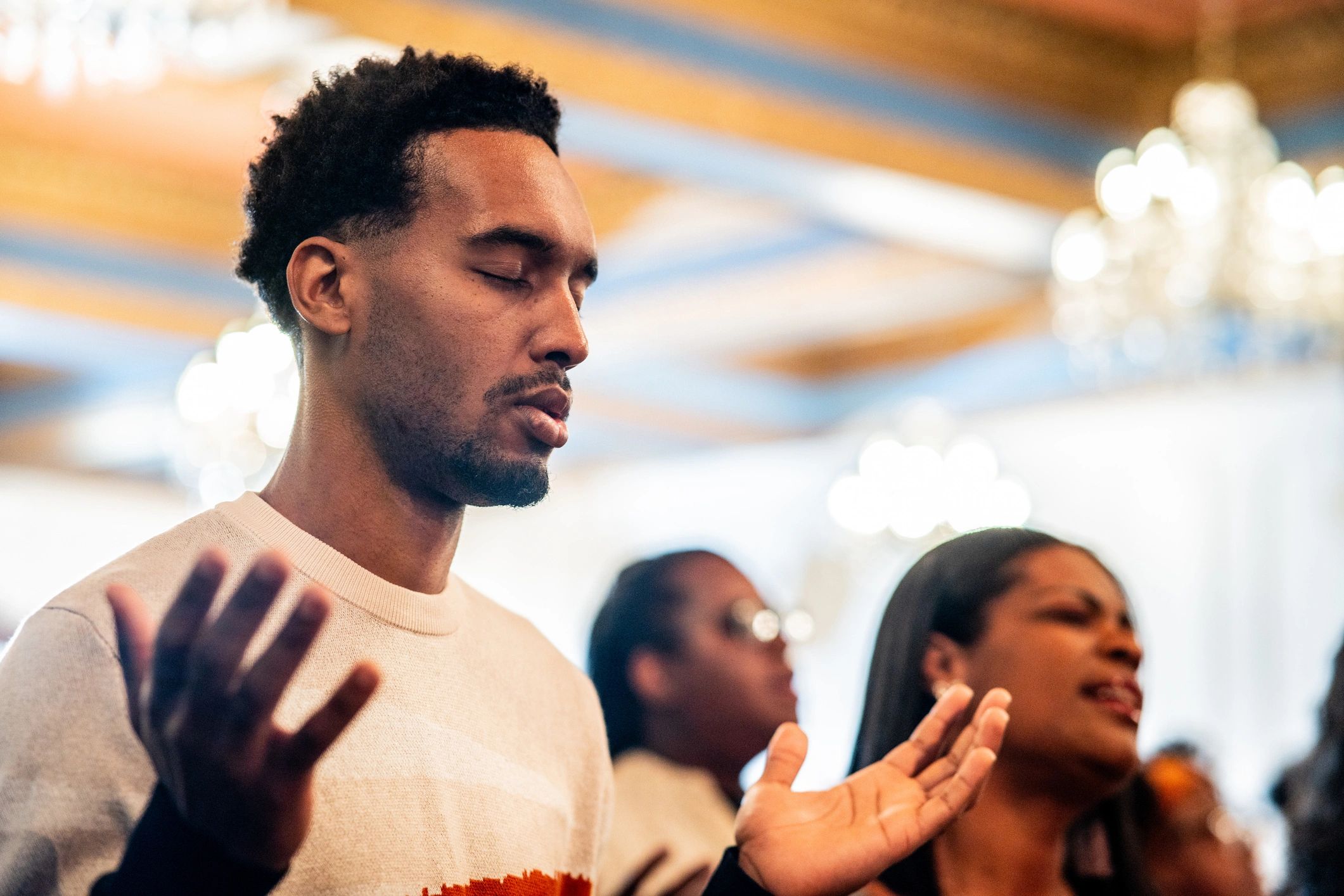 Young adult praying in a church