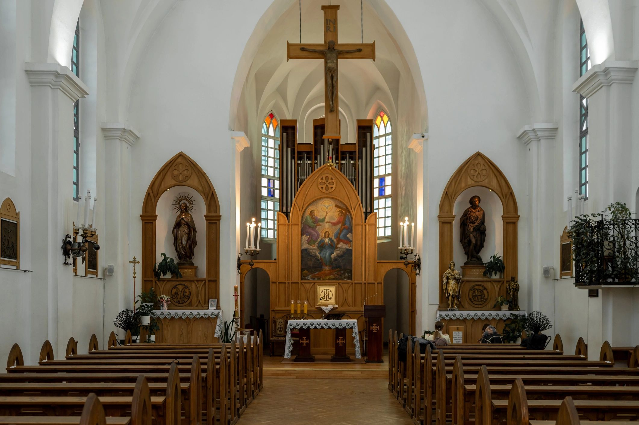 Interior of a Catholic Church with Wooden Pews Altar and Pipe Organ in a Neo-Gothic Style